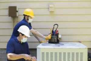 two-technicians-working-on-ac-unit